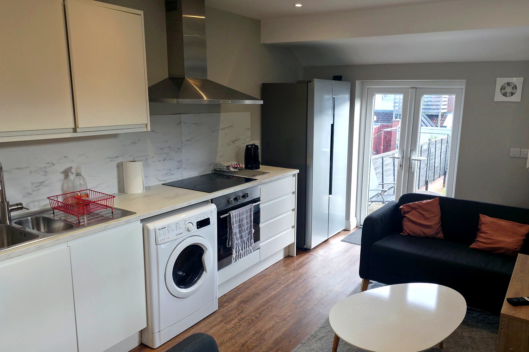 Open-plan kitchen and lounge with garden doors