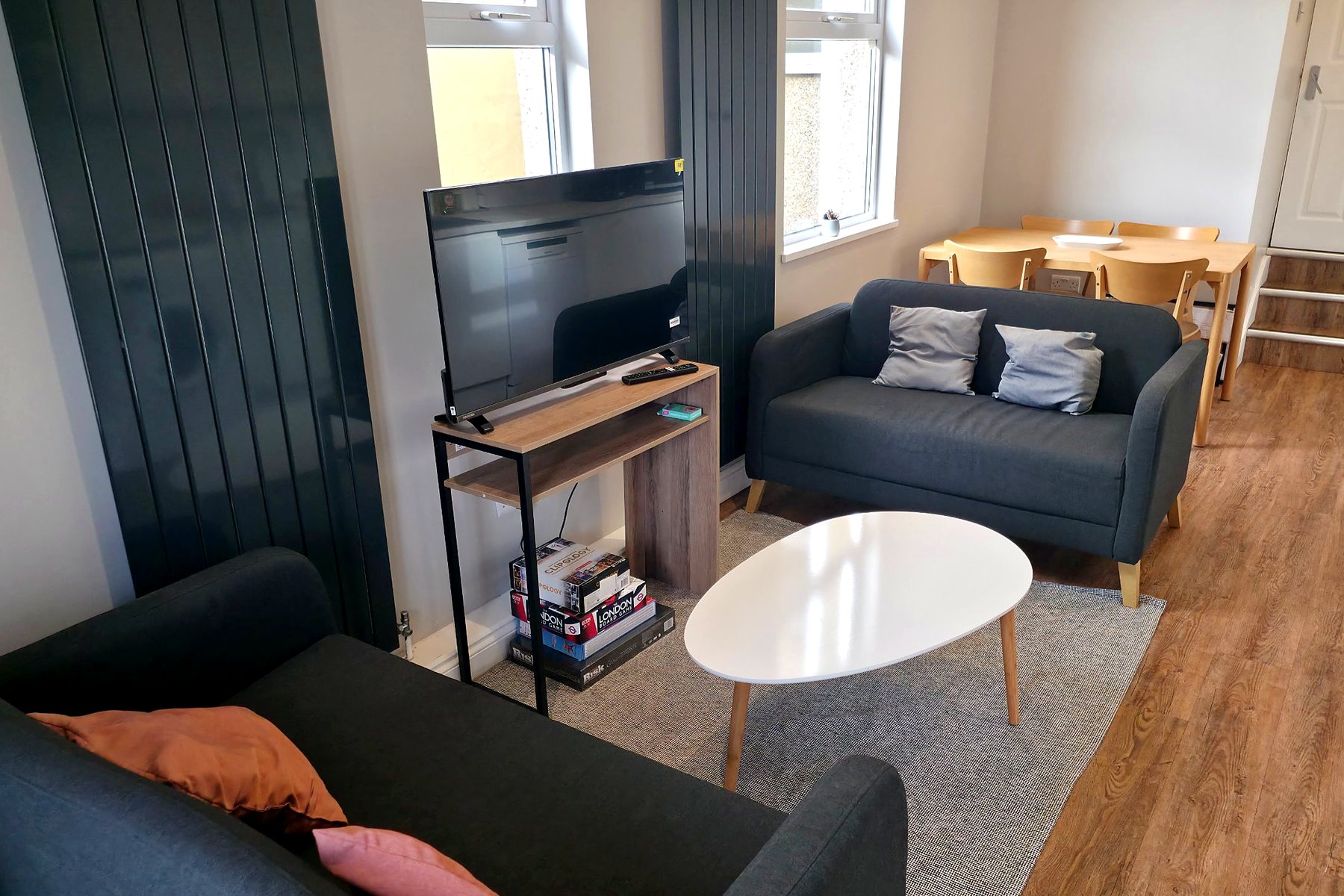 Shared lounge with two sofas, a coffee table and a dining area